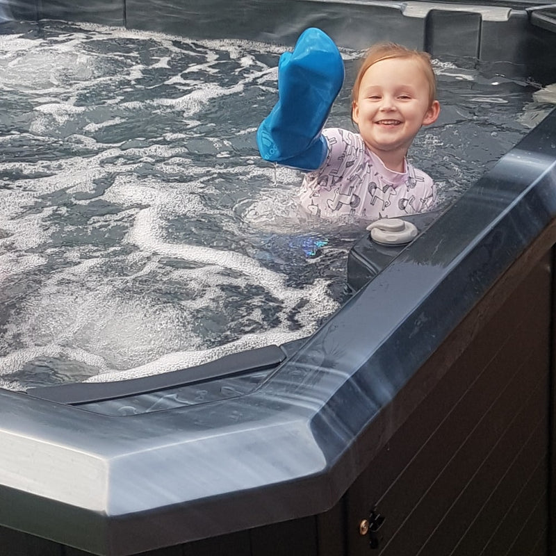 sharleen's daughter wearing her full arm cast cover in the spa pool