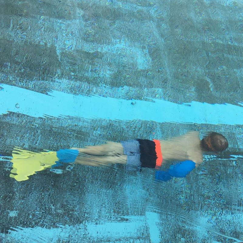 Beth's son swimming underwater with his waterproof full arm cover