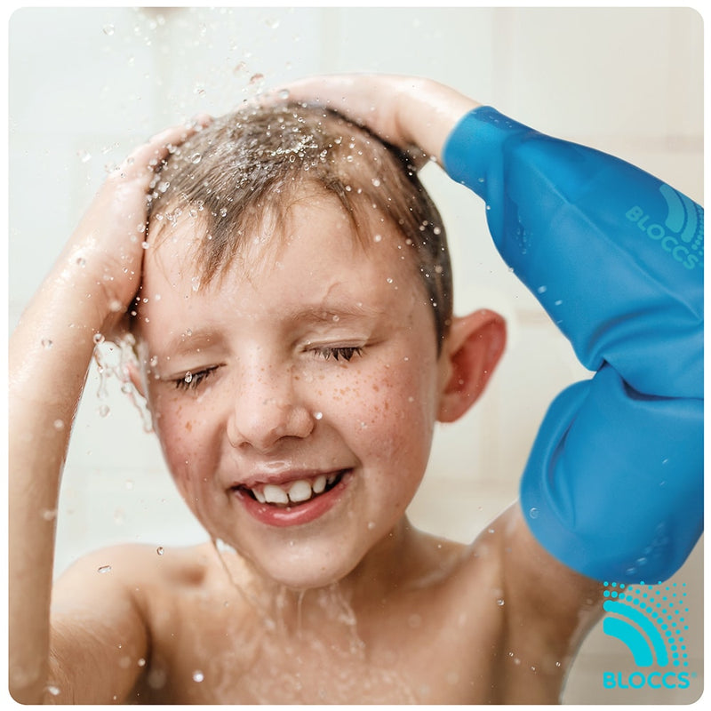 Young boy wearing a bloccs waterproof elbow protector in the shower