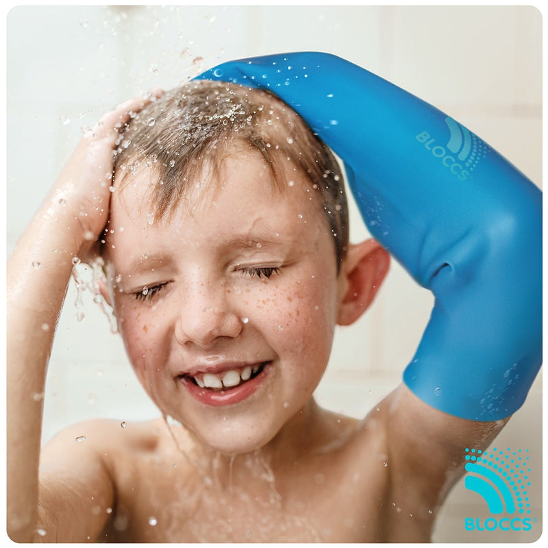 Boy wearing a bloccs full arm cover in the shower