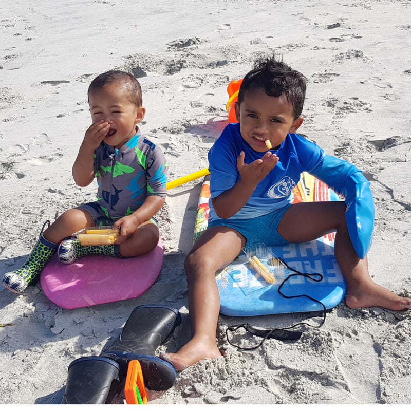 Sitting on a boogie board with a full arm cast cover