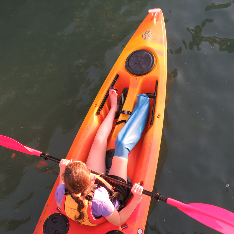 Dani sitting in kayak wearing short leg cast cover