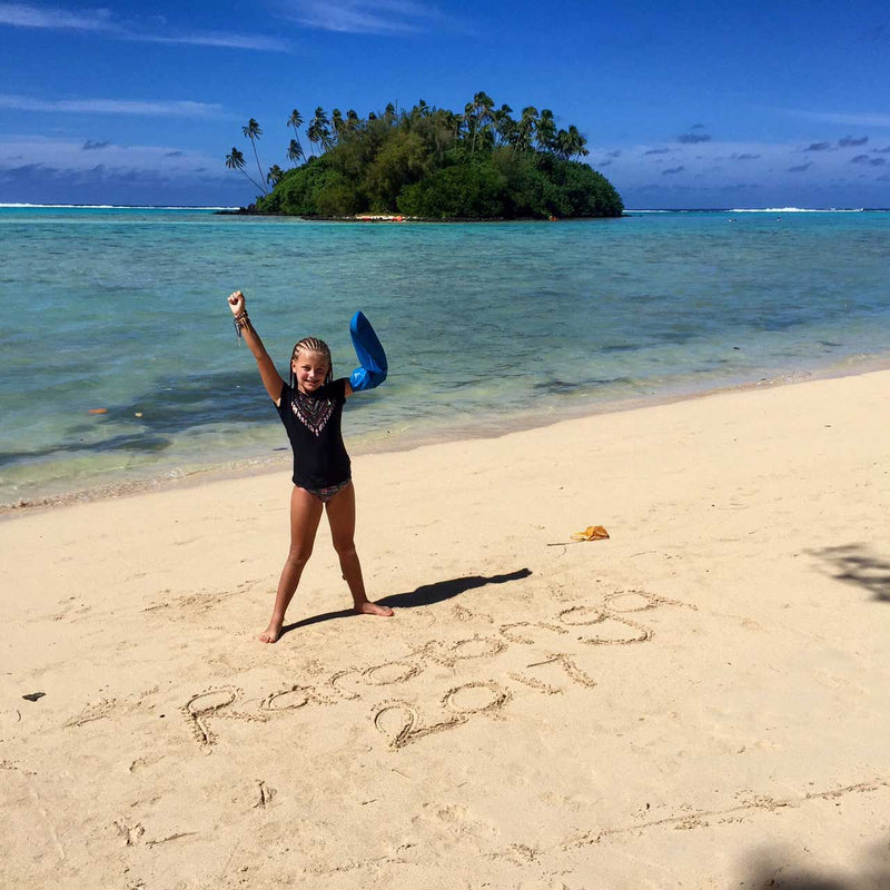 Jenna's daughter wearing her waterproof arm cast protector in Rarotonga