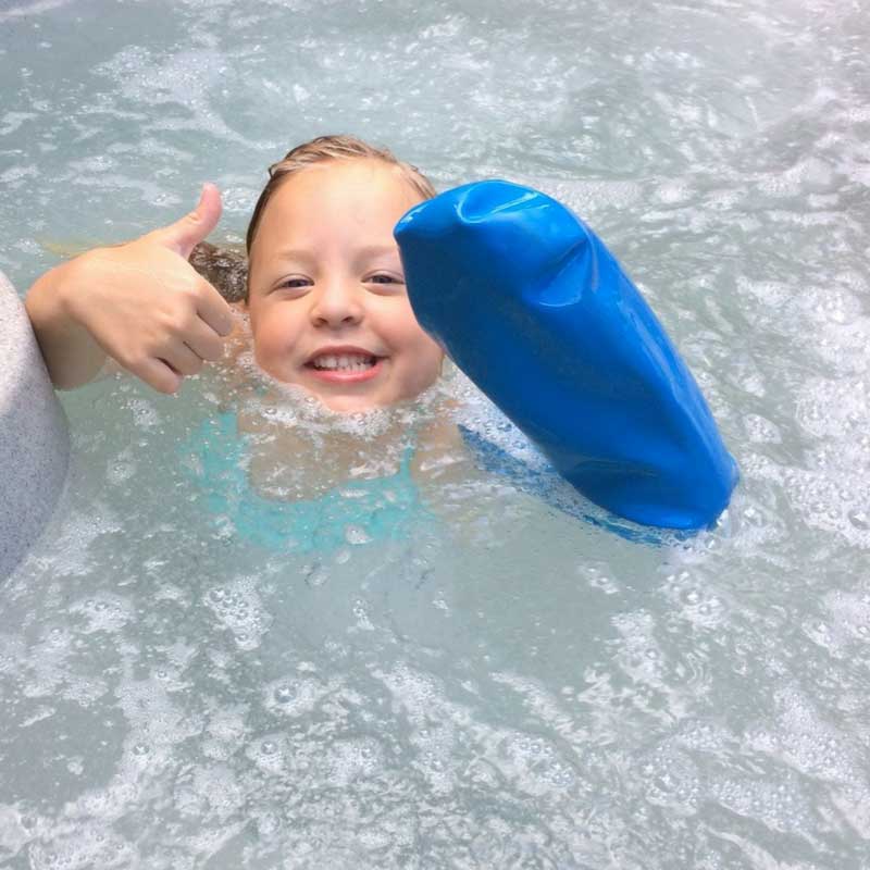 Nikki wearing her Bloccs Waterproof Arm Cast Protector in a spa pool