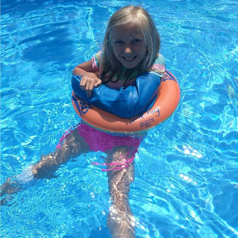 Allegra wearing her Bloccs Waterproof arm cast protector in a swimming pool