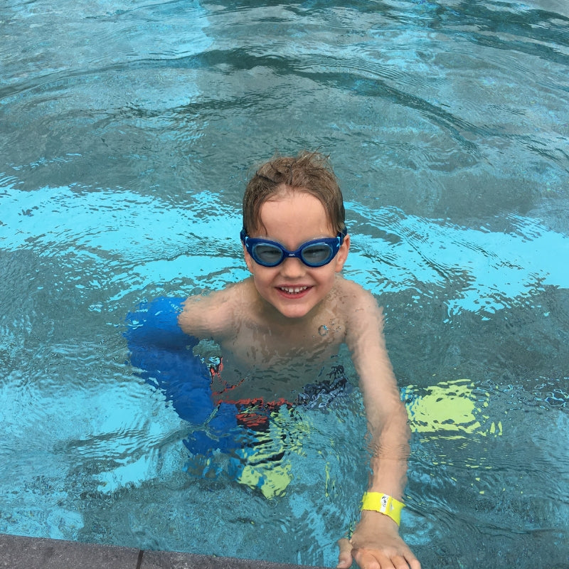 Beth's son swimming with his waterproof full arm cover