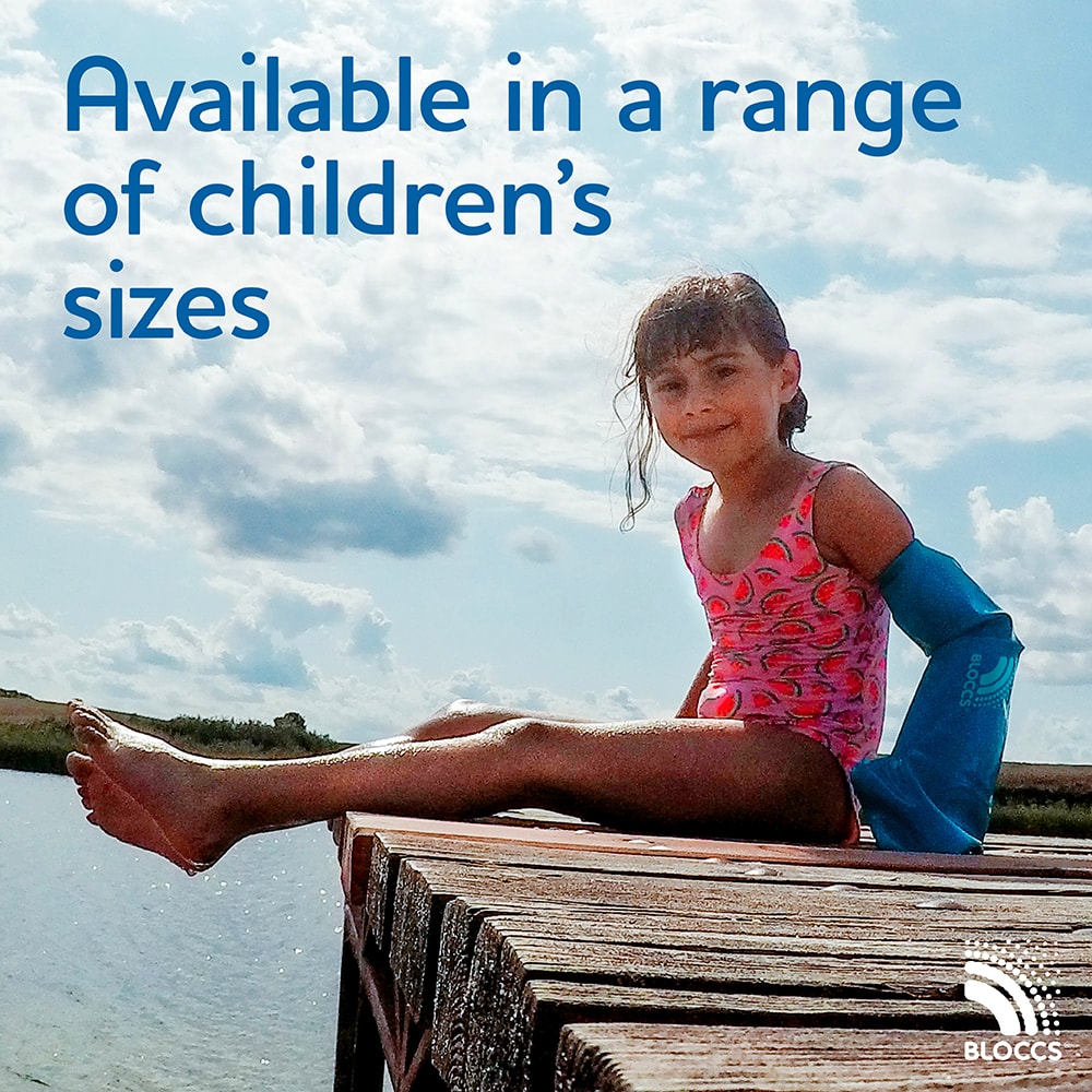 girl sitting on a jetty wearing a full arm cast cover