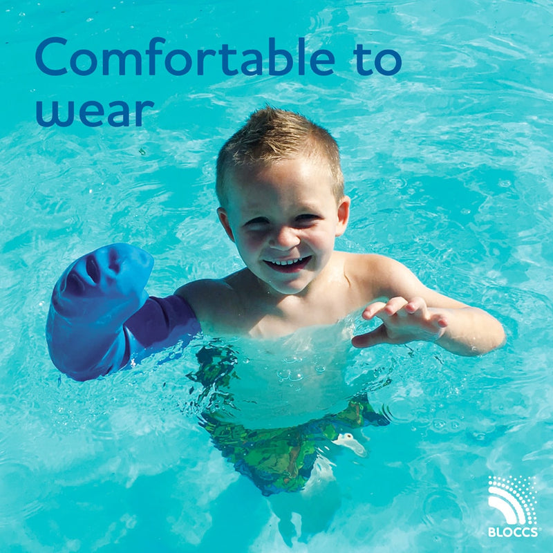 young boy wearing a comfortable bloccs full arm cast cover in a swimming pool